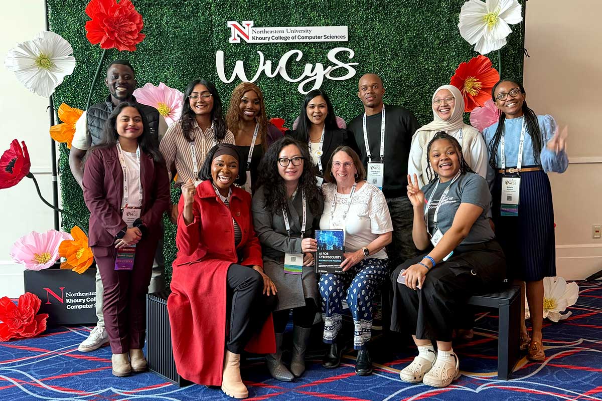 Members of NU Arlington's Women's in Cybersecurity club pose for a photo with faculty