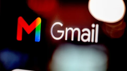 A close up of a screen displaying the large "M" Gmail logo and the word "Gmail"