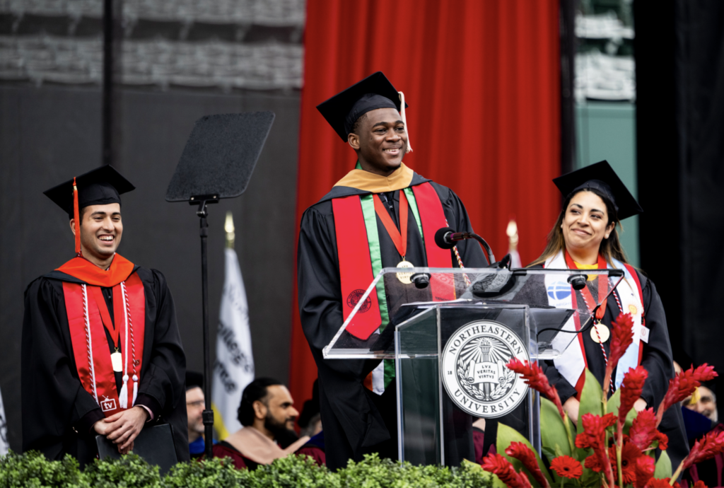 Daniela Gonzalez on stage with other MS graduates at commencement.