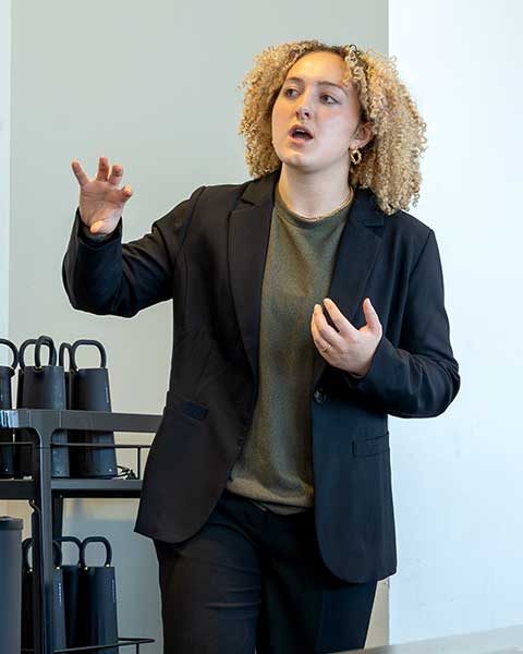A Khoury students gestures as she summarizes a project