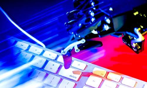 a computer keyboard next to a robotic device