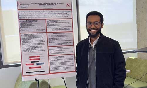 Anania Gebregiorgis stands next to his research poster