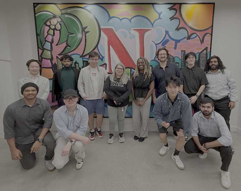 Gabriela Gongora-Svartzman (center) stands with 11 members of the project team in front of a large mural